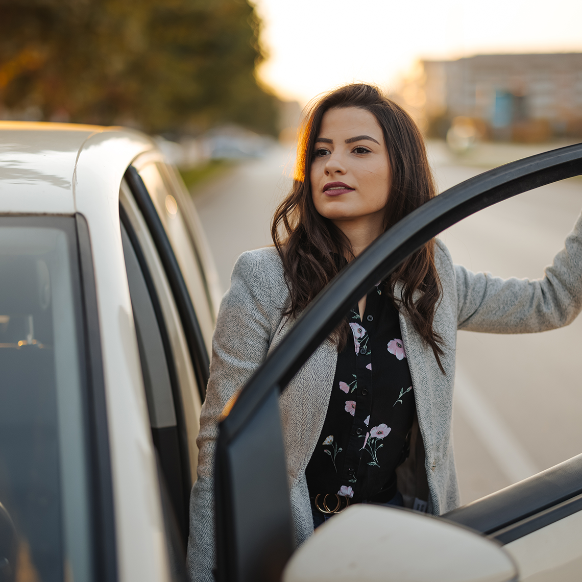 Woman entering or exiting a car