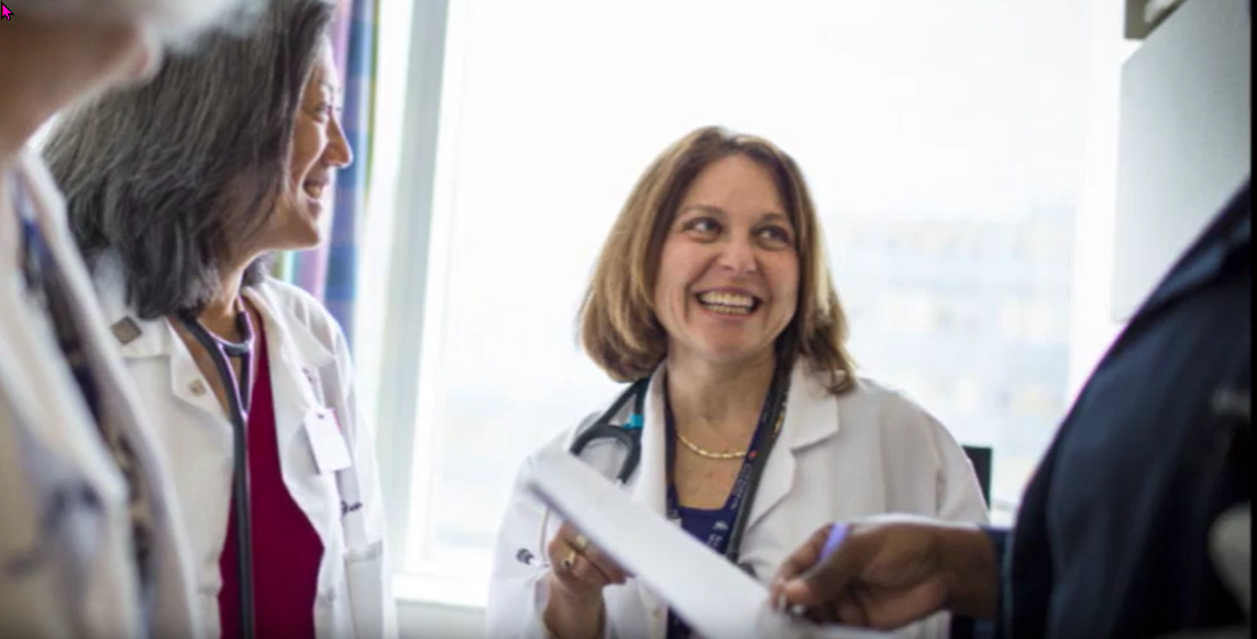 Gila Kriegel, MD smiling and talking with team